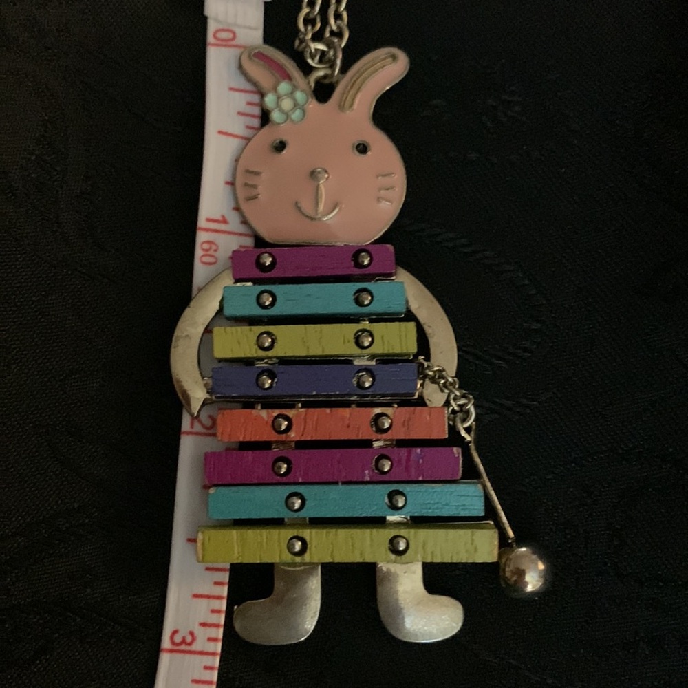 This Necklace Features an Enameled Rabbit Playing a Wooden Colorful Xylophone - Picture 5 of 6